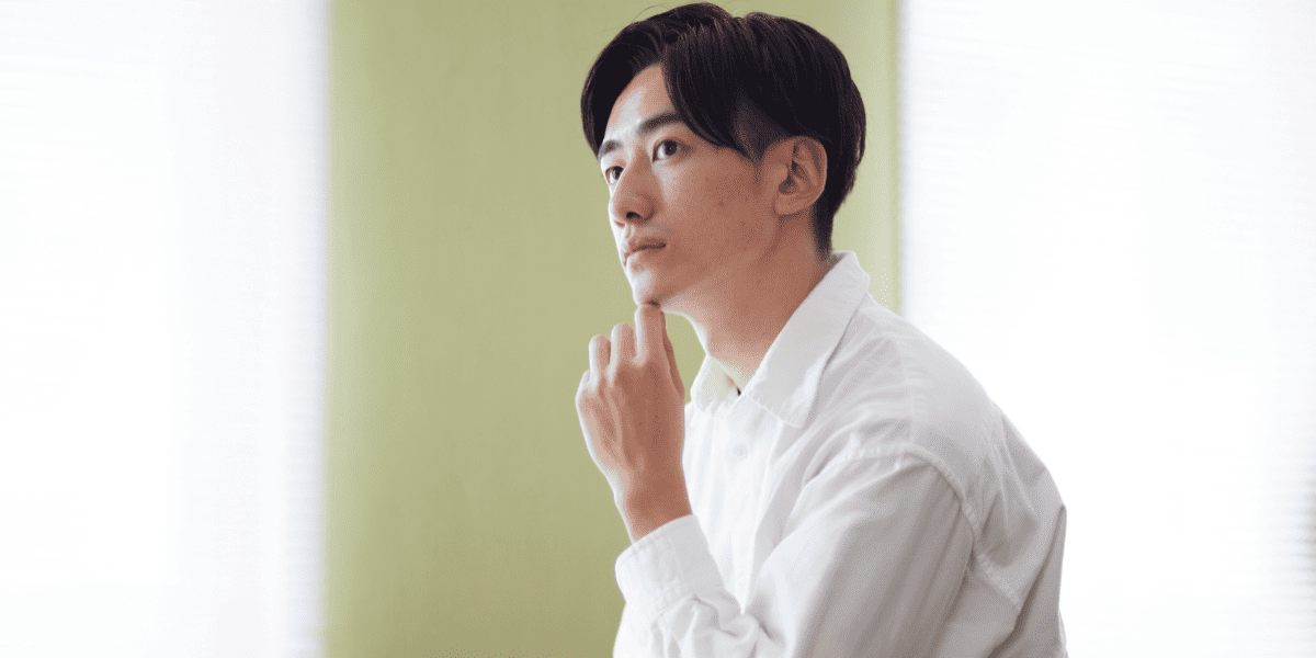 考え事をしている男子高校生