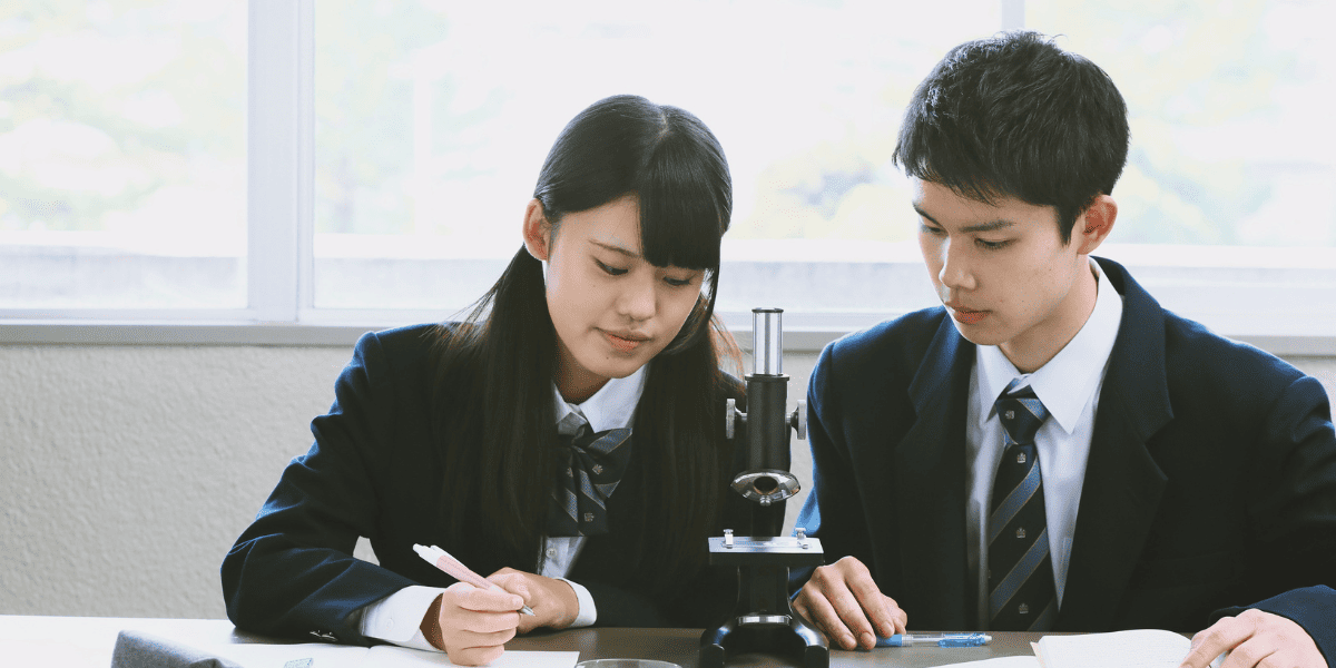 顕微鏡を前に学習する生徒たち
